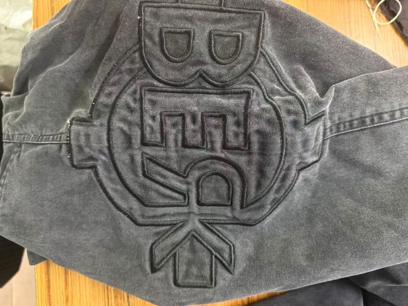Tonal embroidered emblem on a heavyweight garment