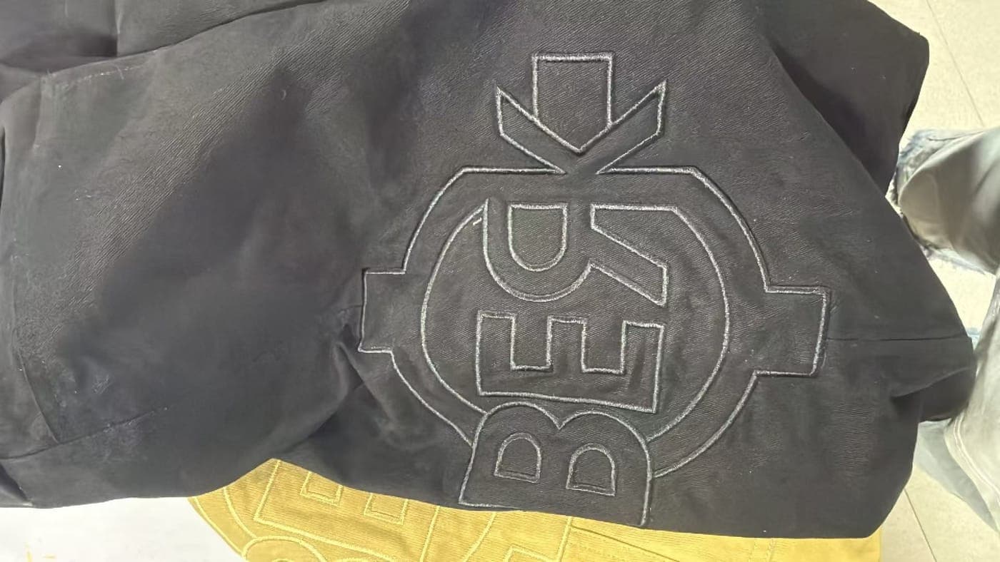 The emblem embroidered across the back of a hood