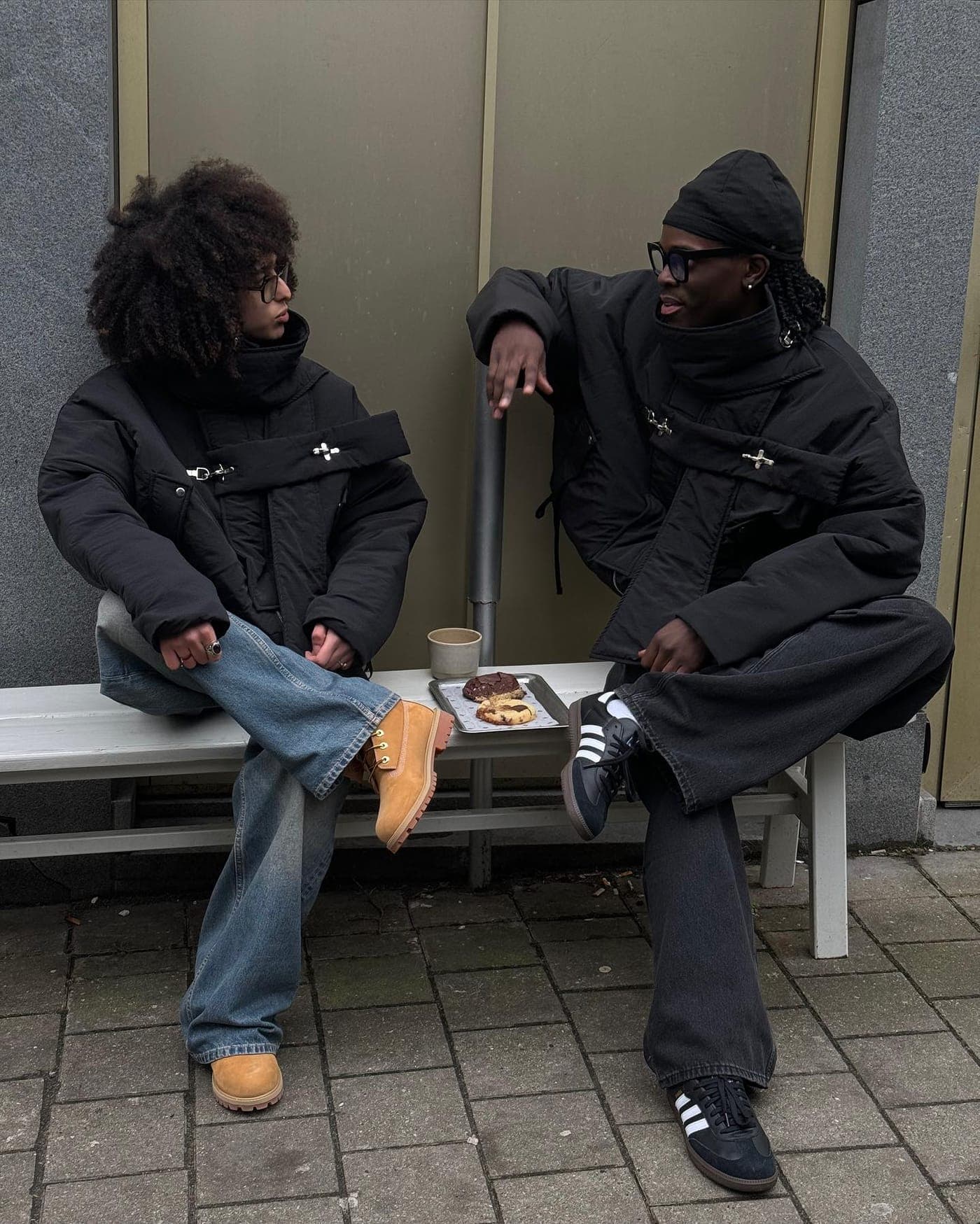Seated pair in outerwear and denim