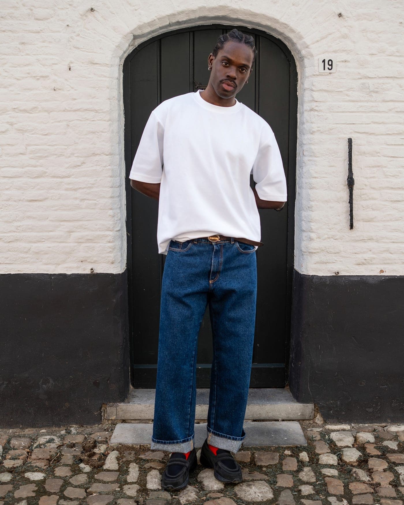 Doorway portrait, tee and denim