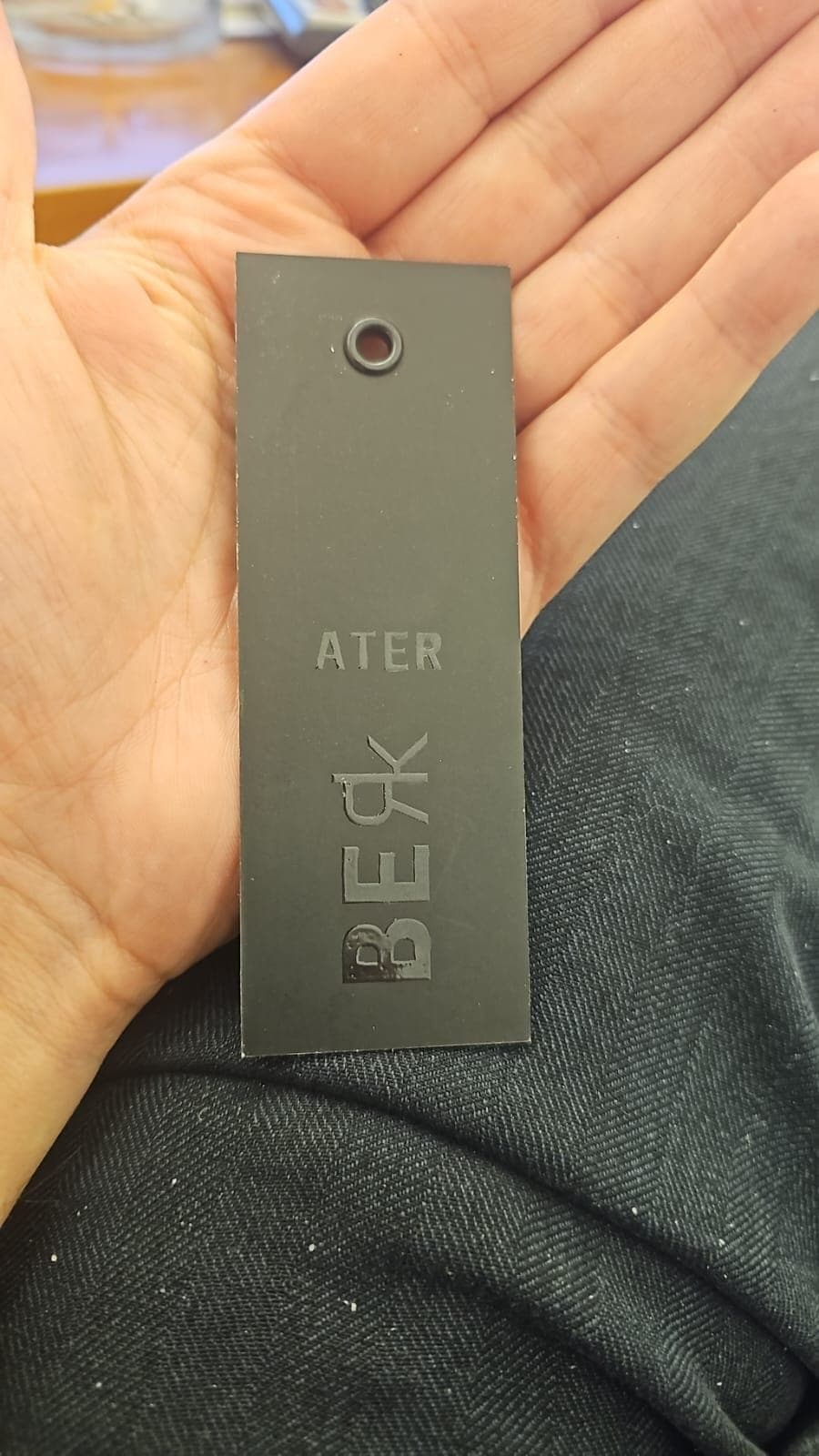 Metal-eyeleted hangtag held in hand