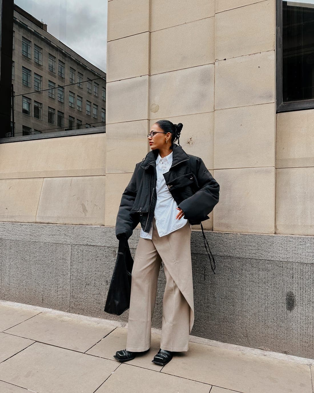 Wearer in outerwear and wide trouser