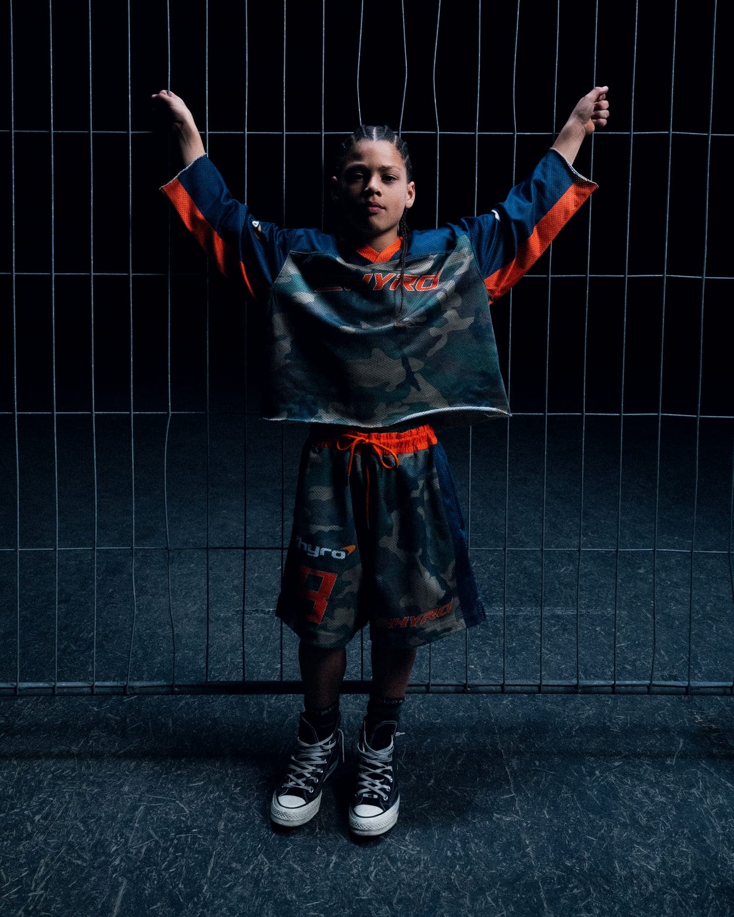Campaign shoot: figure against a lit fence